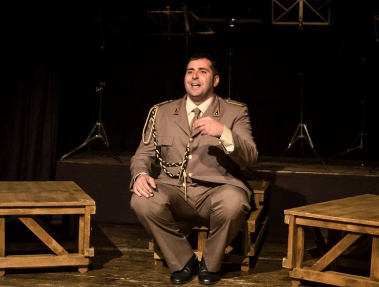 Federico Perrotta a Civitella teatro in scena seduto durante lo spettacolo La Banda